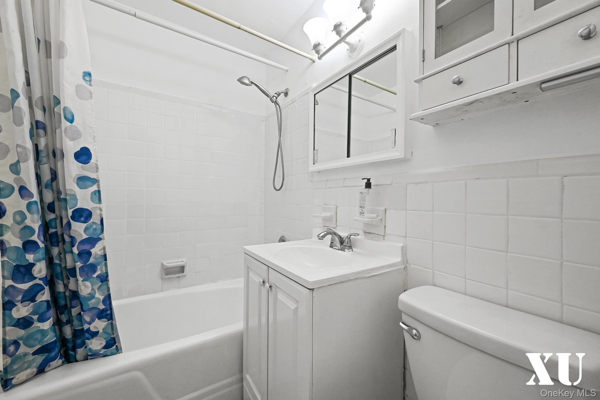 43-10 Kissena Boulevard, Unit 2B Queens, NY 11355 - Photo 10 of 23 a bathroom with a sink a toilet and shower