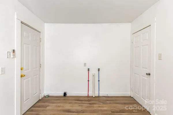 a view of a room with wooden floor