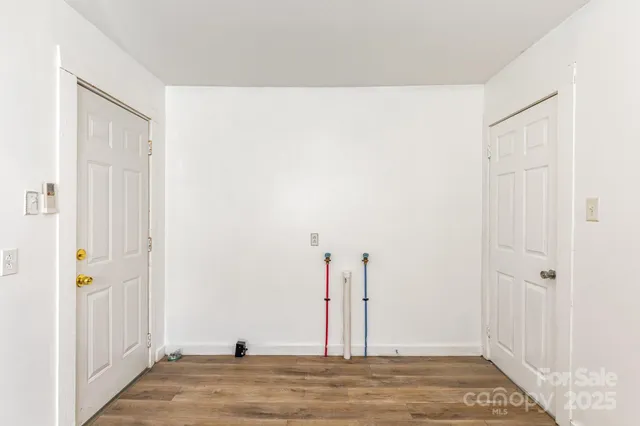 a view of a room with wooden floor