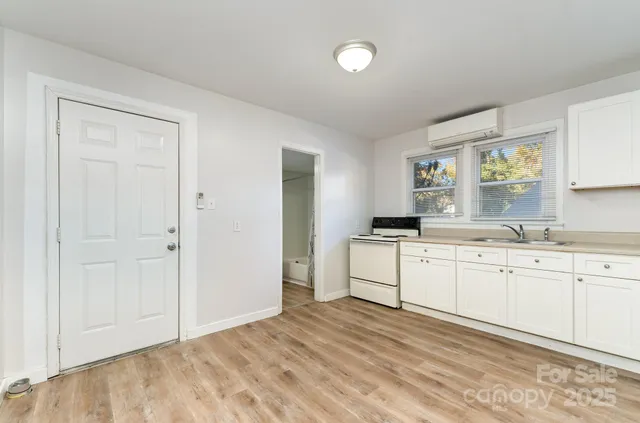 a room with a white cabinets and sink