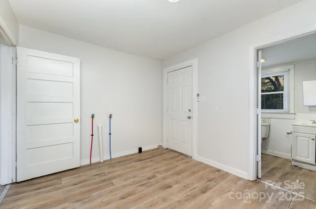 a view of a livingroom with wooden floor and cabinet