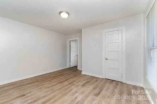 a view of an empty room and wooden floor