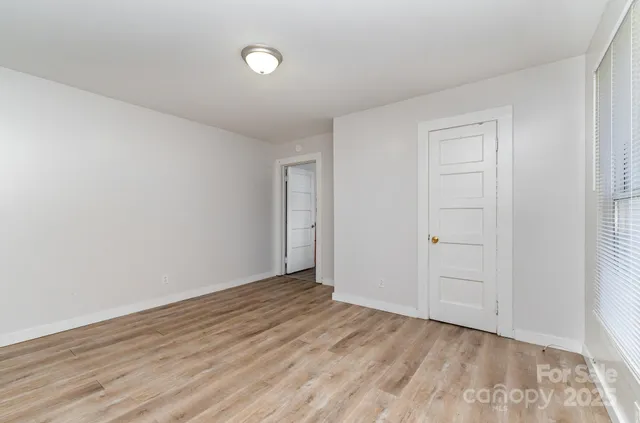 a view of an empty room and wooden floor
