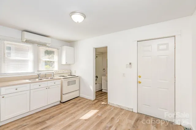 a kitchen with a stove a sink and a refrigerator