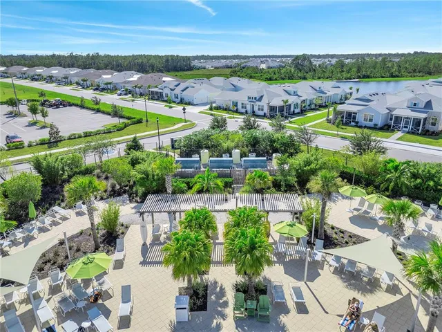 an aerial view of a house with a yard basket ball court and outdoor seating