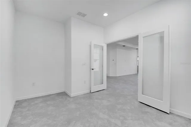 a bathroom with a granite countertop sink a toilet and mirror