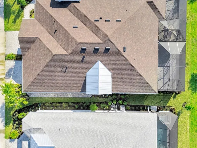 an aerial view of a house with yard and garage