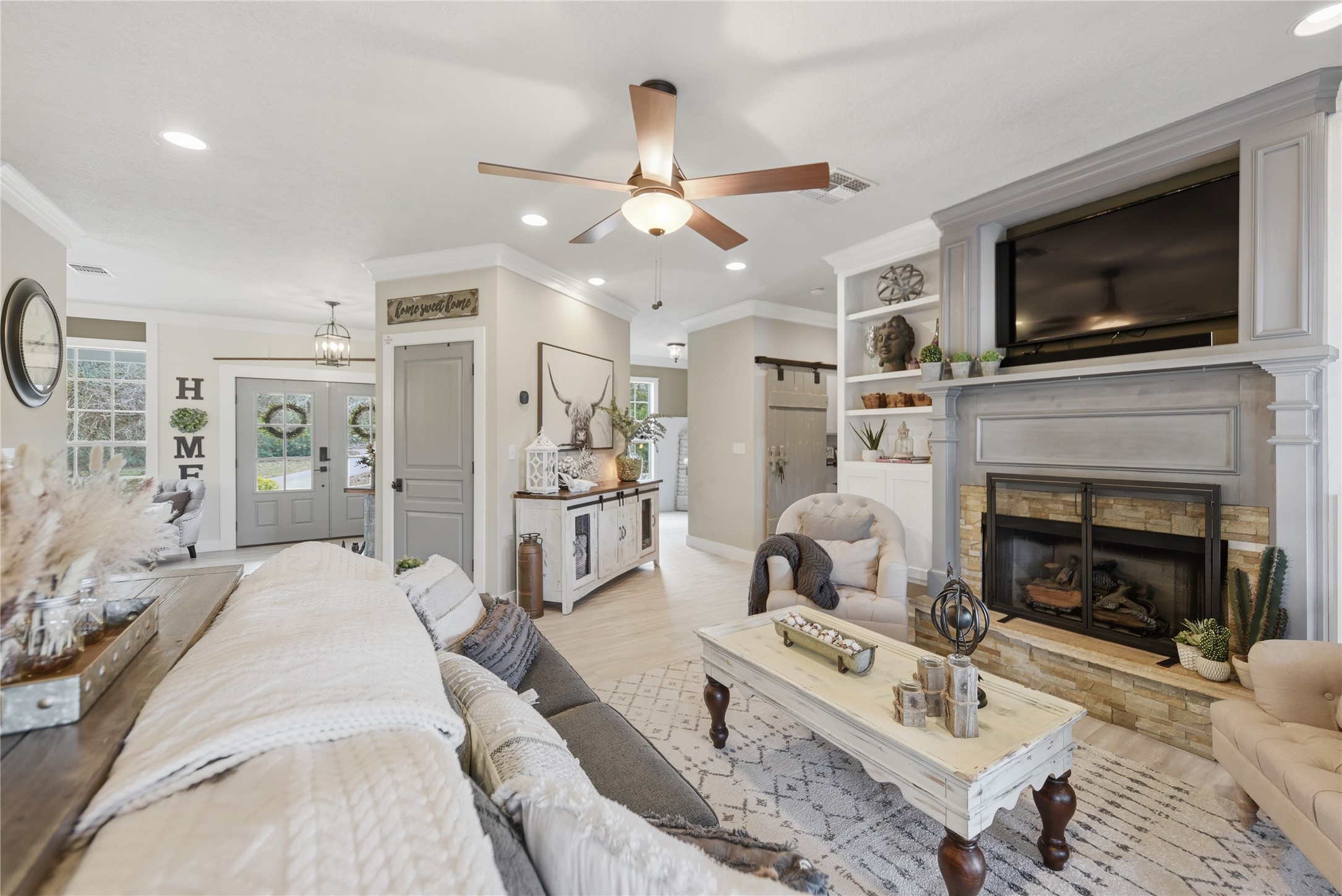 a living room with furniture a flat screen tv and a fireplace