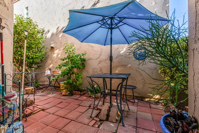 a view of a chairs and table in backyard