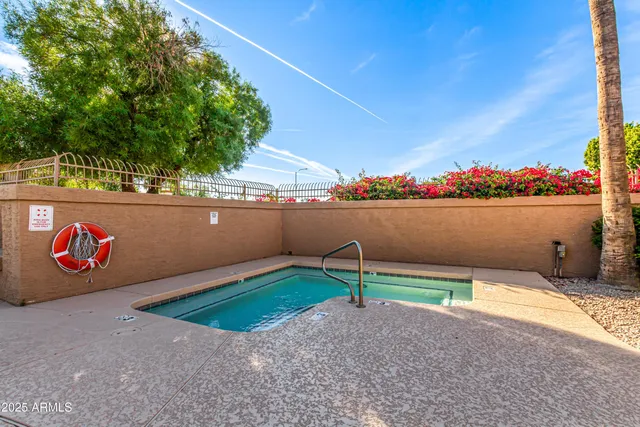 a view of a swimming pool with an outdoor seating and a yard