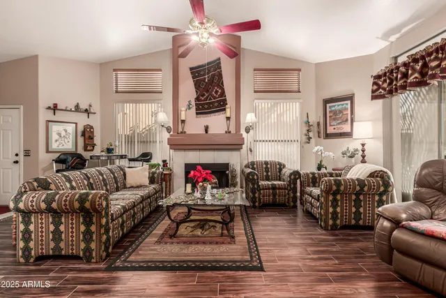 a living room with furniture a fireplace and a flat screen tv
