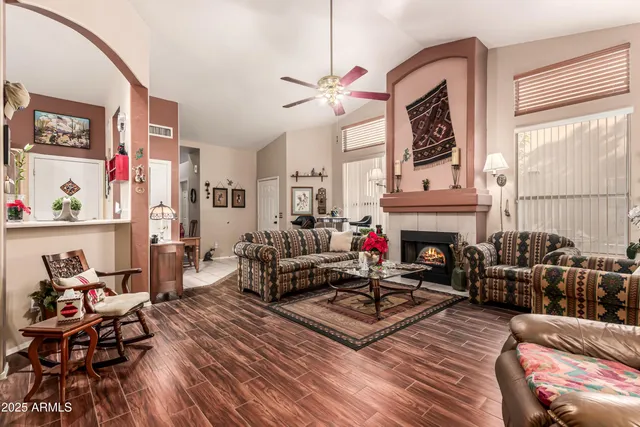 a living room with furniture a fireplace and a window