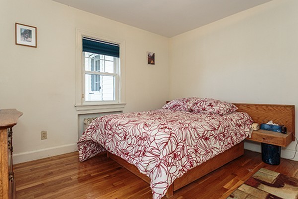 46 Lansdowne Road Arlington, MA 02474 - Photo 16 of 29 a bedroom with a bed and wooden floor