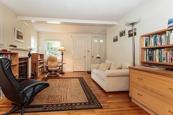 46 Lansdowne Road Arlington, MA 02474 - Photo 4 of 29 a living room with furniture hard wood floor and a book shelf