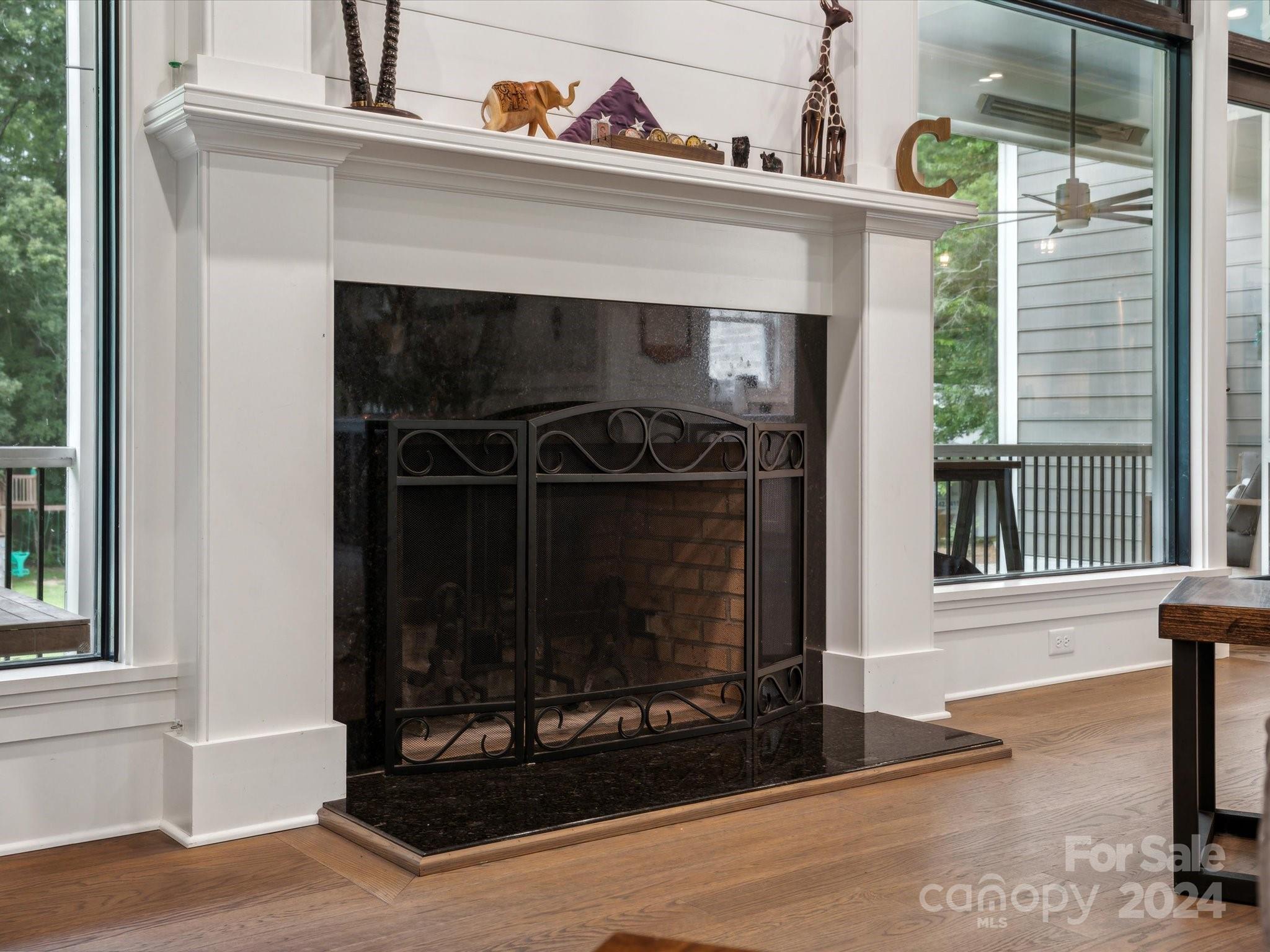 1156 Williams Road Fort Mill, SC 29715 - Photo 13 of 44 a living room with a fireplace windows and a wooden floor