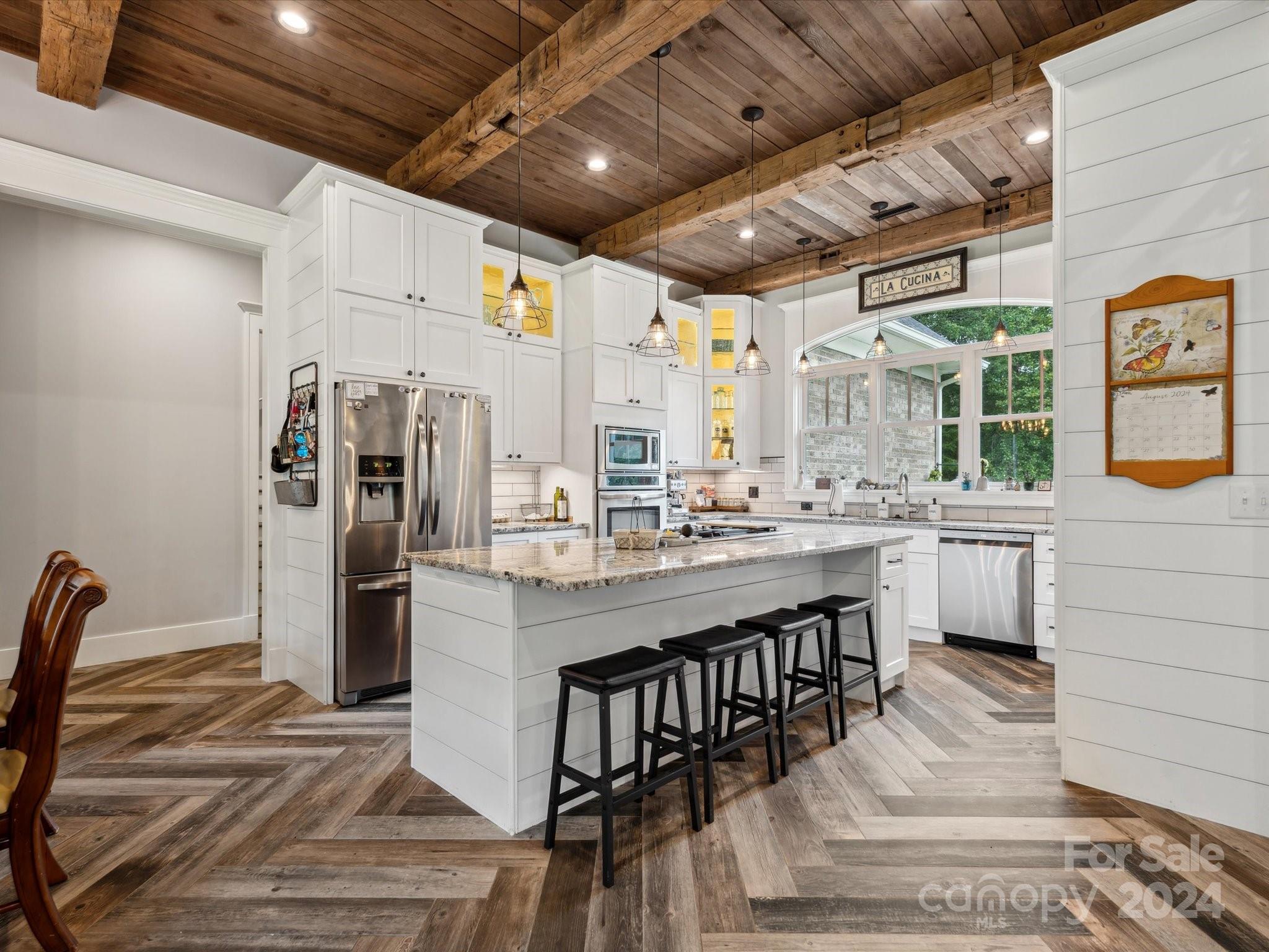 1156 Williams Road Fort Mill, SC 29715 - Photo 14 of 44 a kitchen with stainless steel appliances kitchen island granite countertop a table chairs and a refrigerator