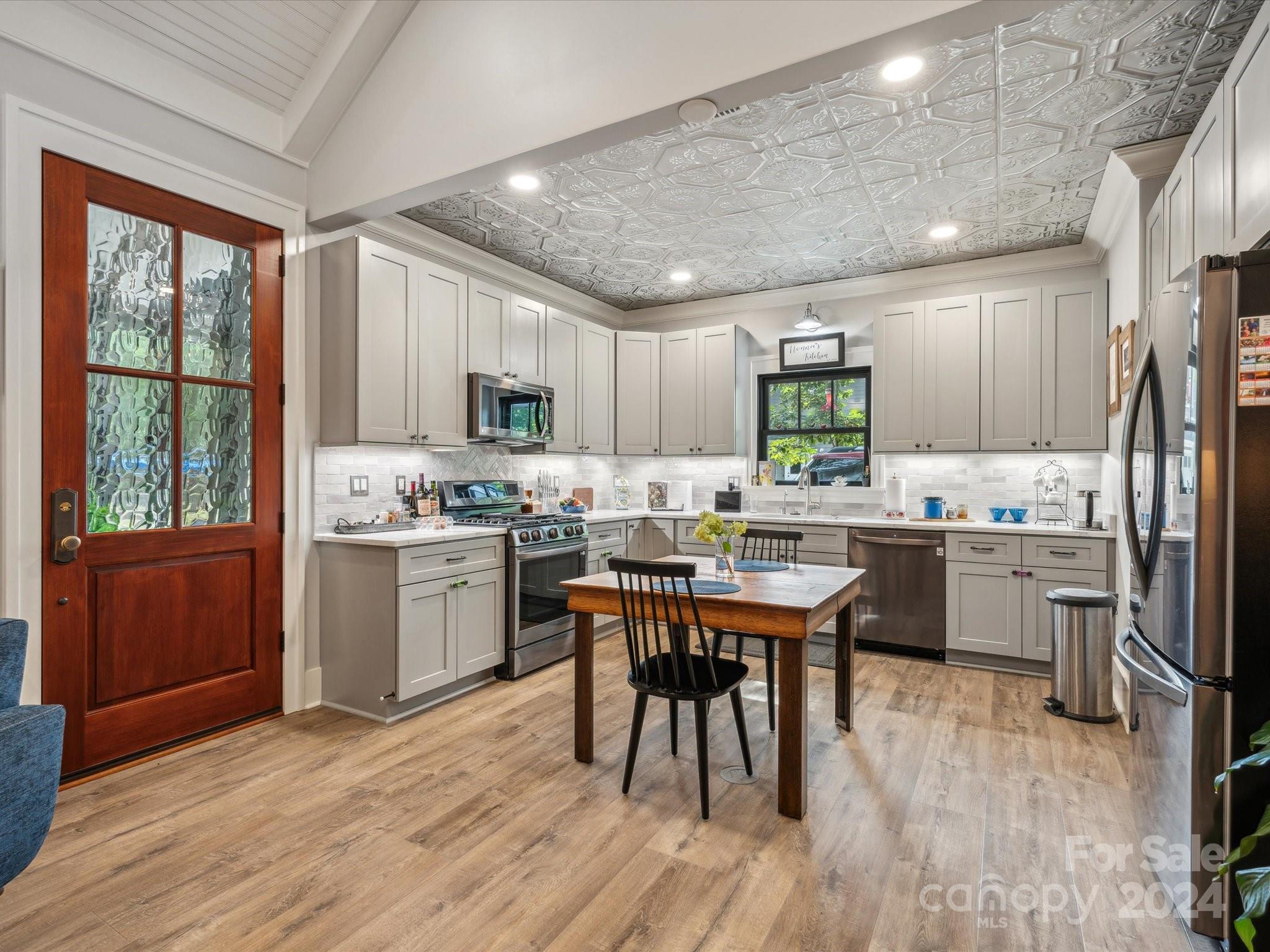 1156 Williams Road Fort Mill, SC 29715 - Photo 36 of 44 a kitchen with a sink a stove a refrigerator cabinets and wooden floor