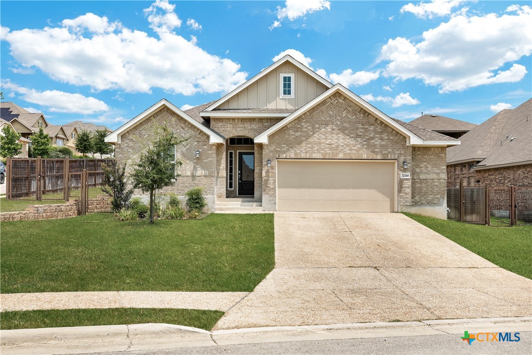 32144 Cardamom Way Bulverde, TX 78163 - Photo 1 of 30 a front view of a house with a garden and plants