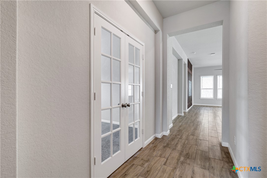 32144 Cardamom Way Bulverde, TX 78163 - Photo 18 of 30 a view of a hallway with wooden floor