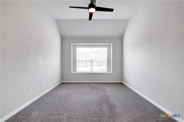 a view of room with window and ceiling fan
