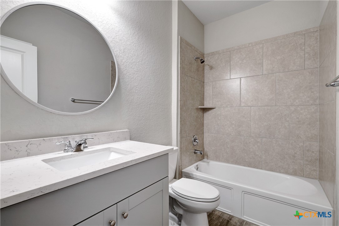 32144 Cardamom Way Bulverde, TX 78163 - Photo 21 of 30 a bathroom with a sink a toilet and a bathtub