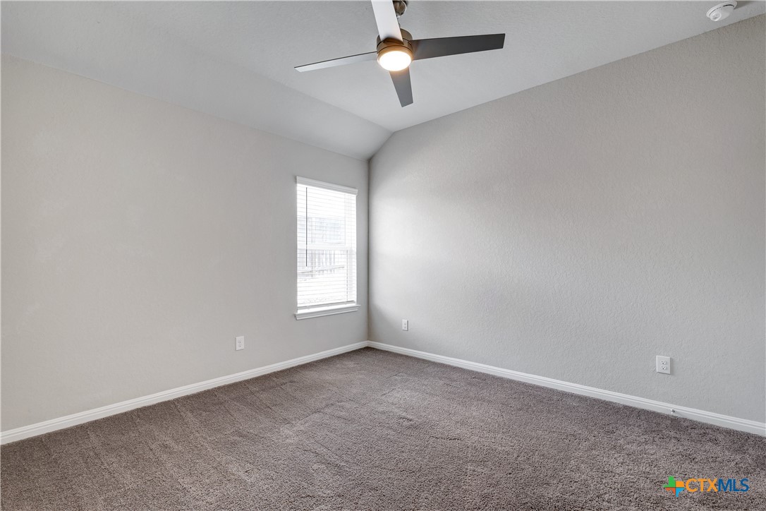 32144 Cardamom Way Bulverde, TX 78163 - Photo 22 of 30 an empty room with a window and ceiling fan