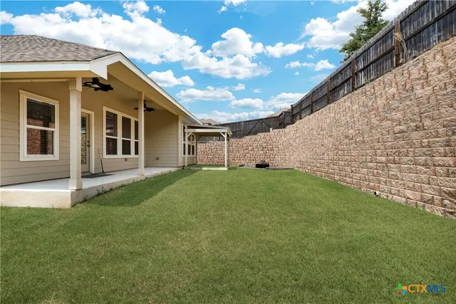 a view of a house with a backyard