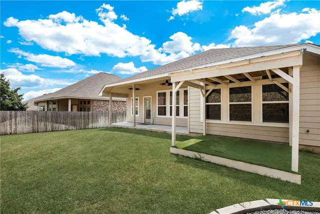 a view of a house with a backyard