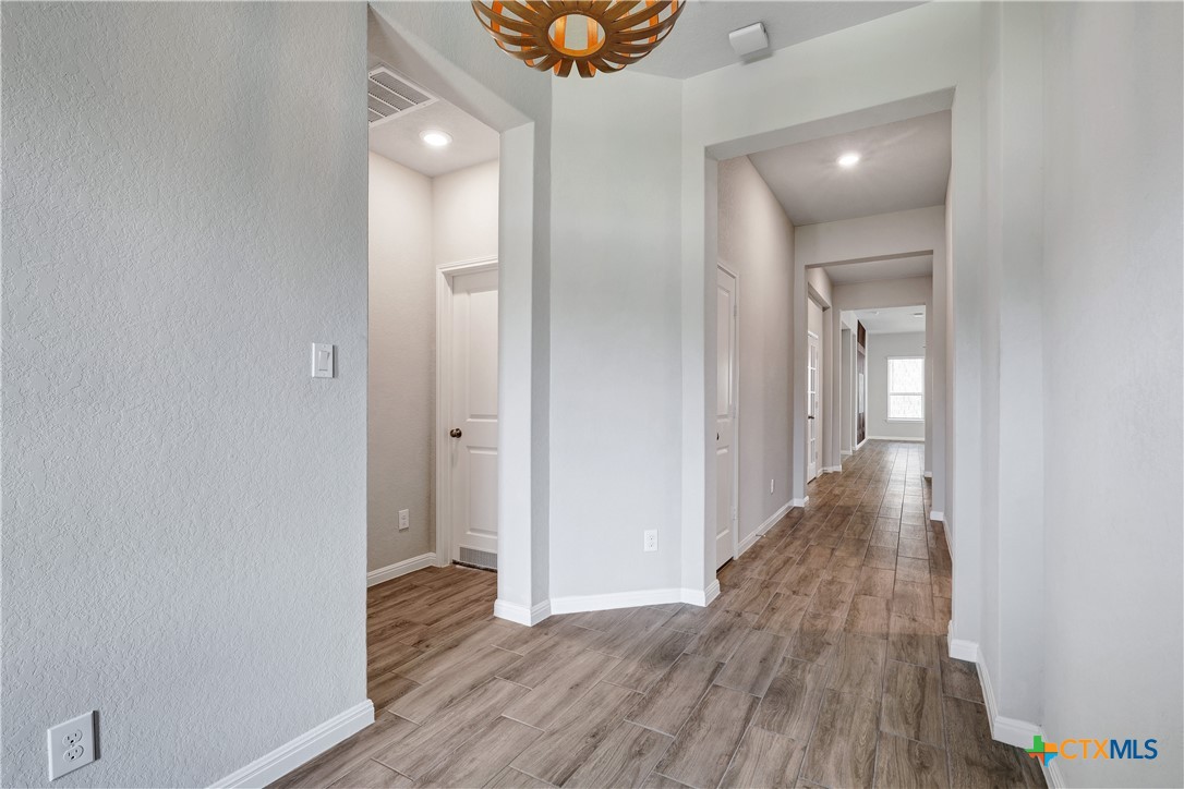 32144 Cardamom Way Bulverde, TX 78163 - Photo 3 of 30 a view of a hallway with wooden floor