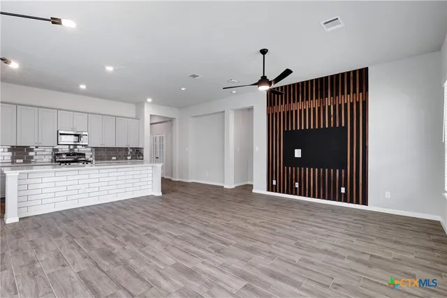 a view of large kitchen with wooden floor