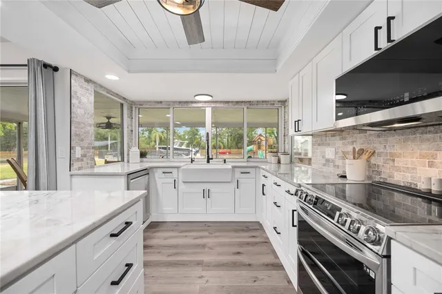 a large kitchen with a large window and stainless steel appliances