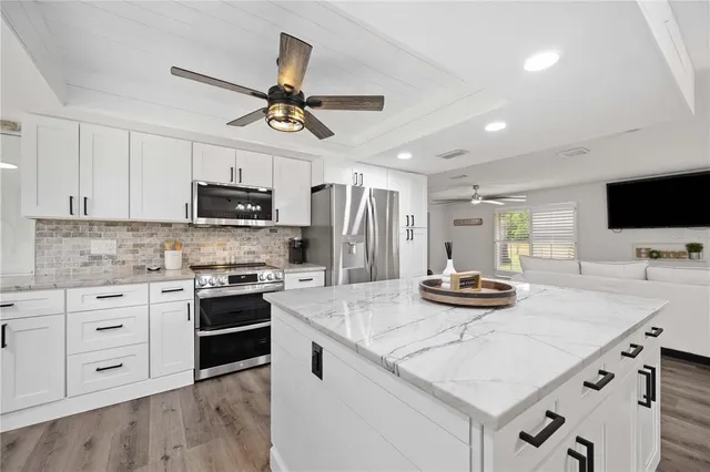 a kitchen with appliances cabinets a sink and a stove