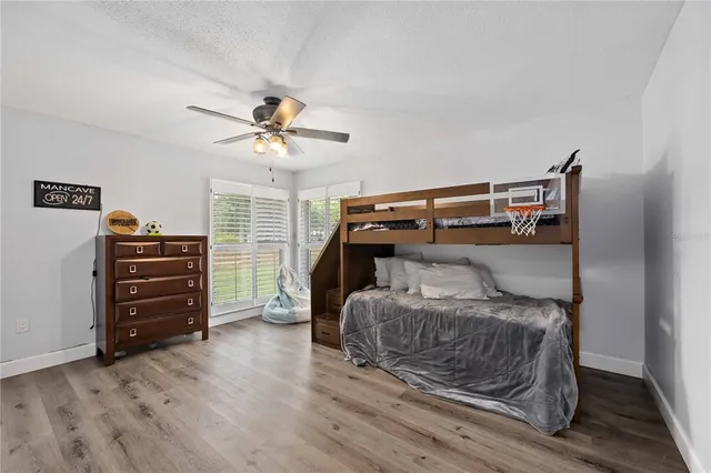 a bedroom with a bed and a ceiling fan