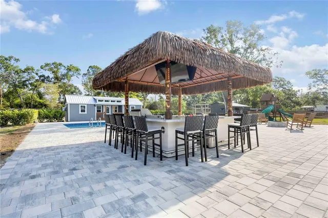 a view of a patio with a table and chairs under an umbrella