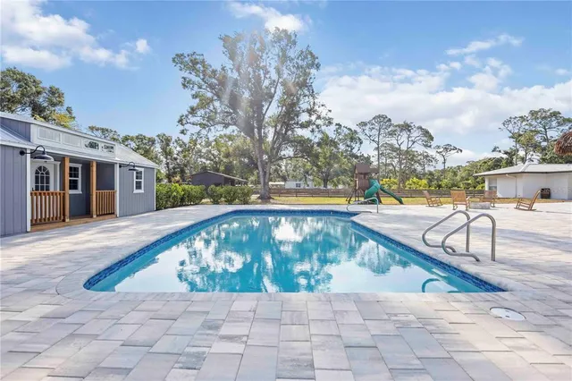 a view of swimming pool with a lounge chairs