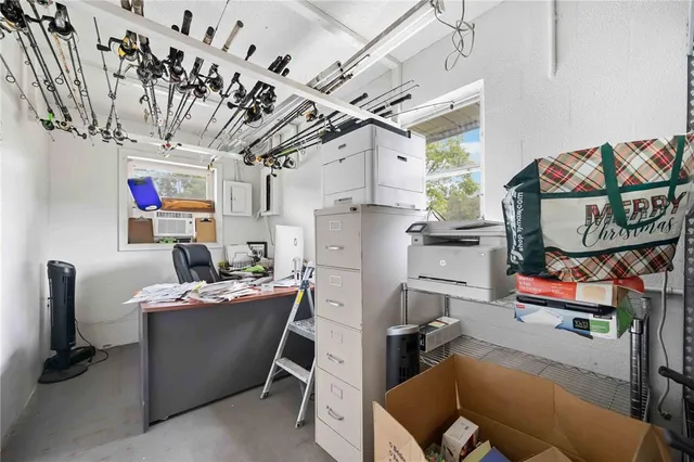 a utility room with cabinets dryer and a chandelier