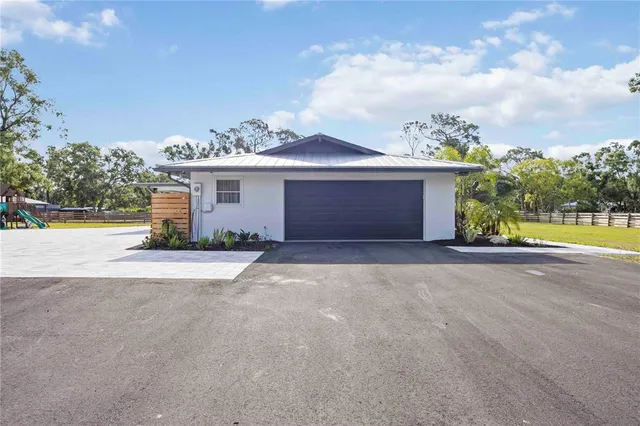 a view of a house with a yard and a garage