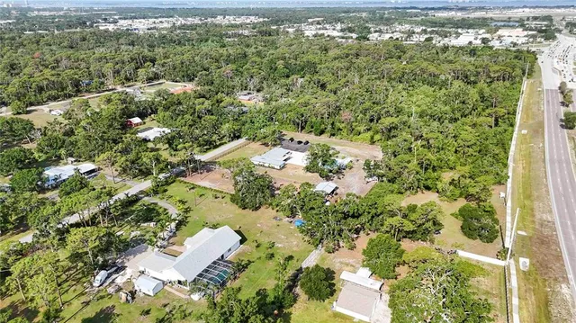 an aerial view of residential house with parking space and trees