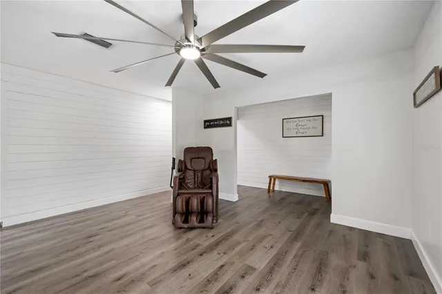 a view of room with hardwood floor and ceiling fan