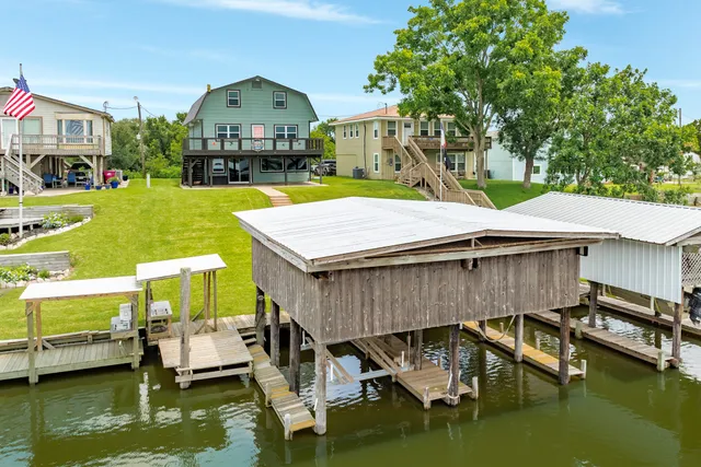 a aerial view of a house with swimming pool and a yard with green space