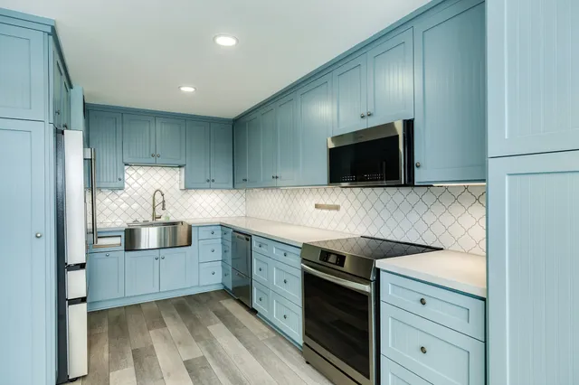 a kitchen with stainless steel appliances a refrigerator stove and microwave