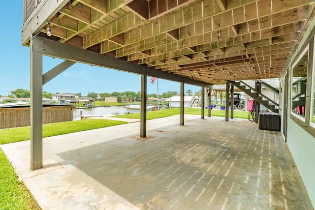 a view of porch with a large window and wooden floor