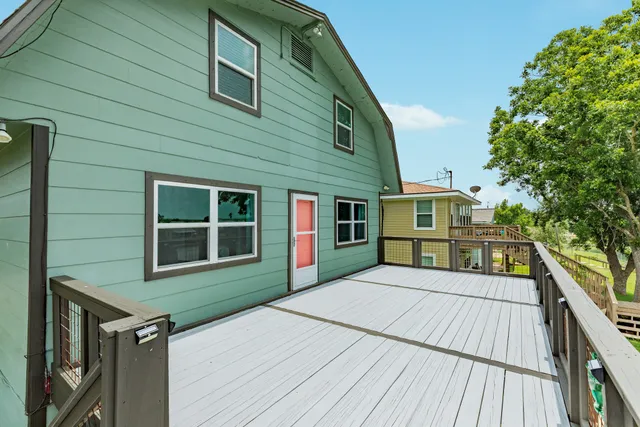 a view of empty room with kitchen and window