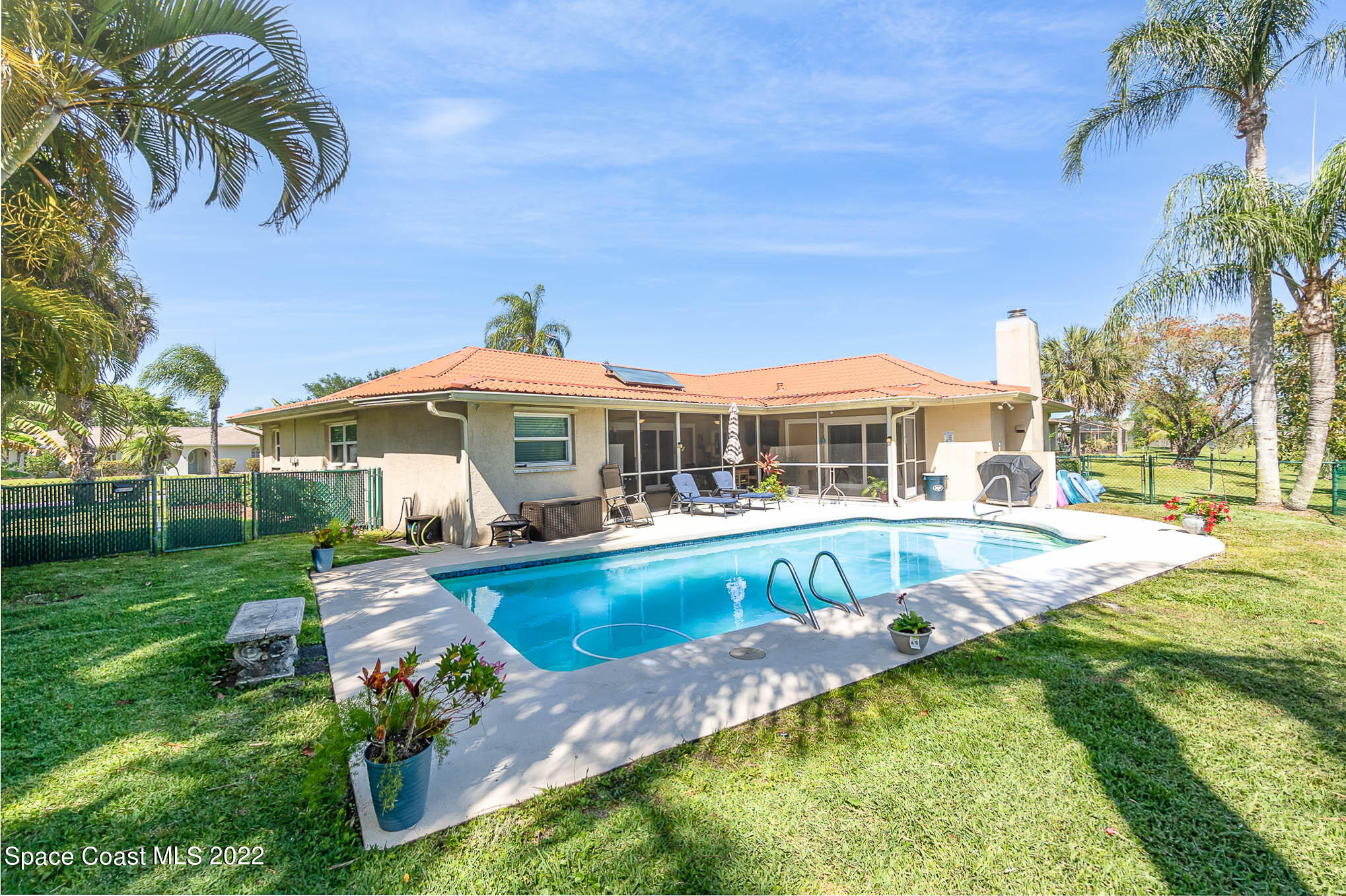 a view of a house with swimming pool and a yard