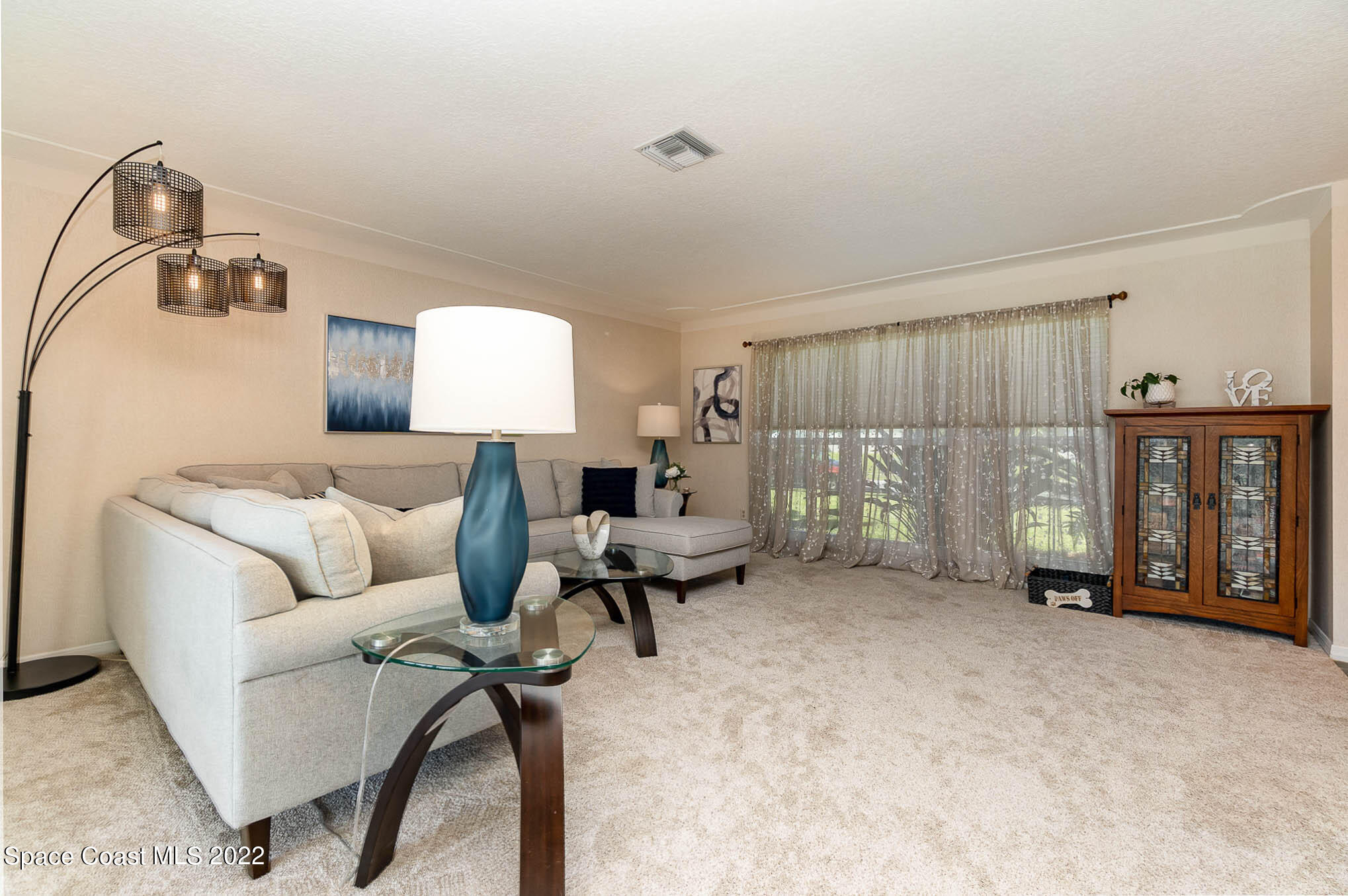 1496 Meadowbrook Road Northeast Palm Bay, FL 32905 - Photo 11 of 25 a living room with furniture and a window