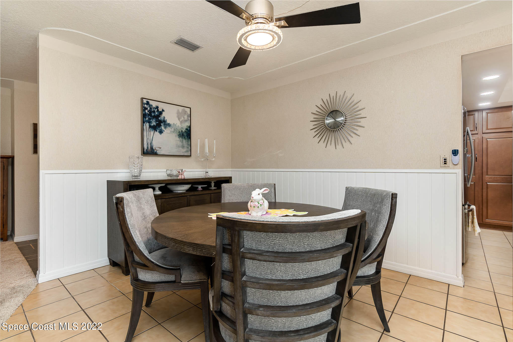 1496 Meadowbrook Road Northeast Palm Bay, FL 32905 - Photo 12 of 25 a view of a dining room with furniture and a chandelier fan