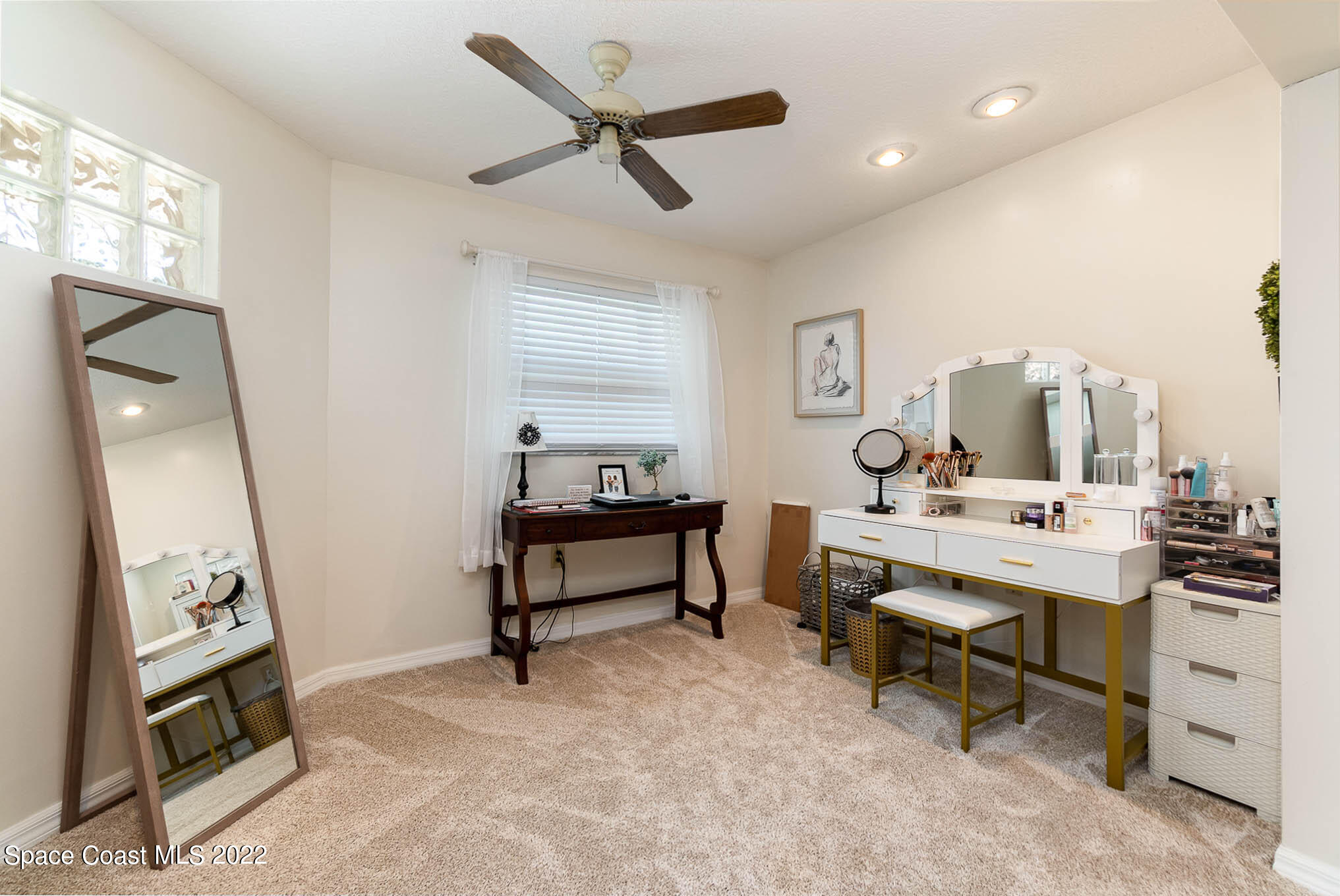 1496 Meadowbrook Road Northeast Palm Bay, FL 32905 - Photo 13 of 25 a view of a workspace with furniture and a window