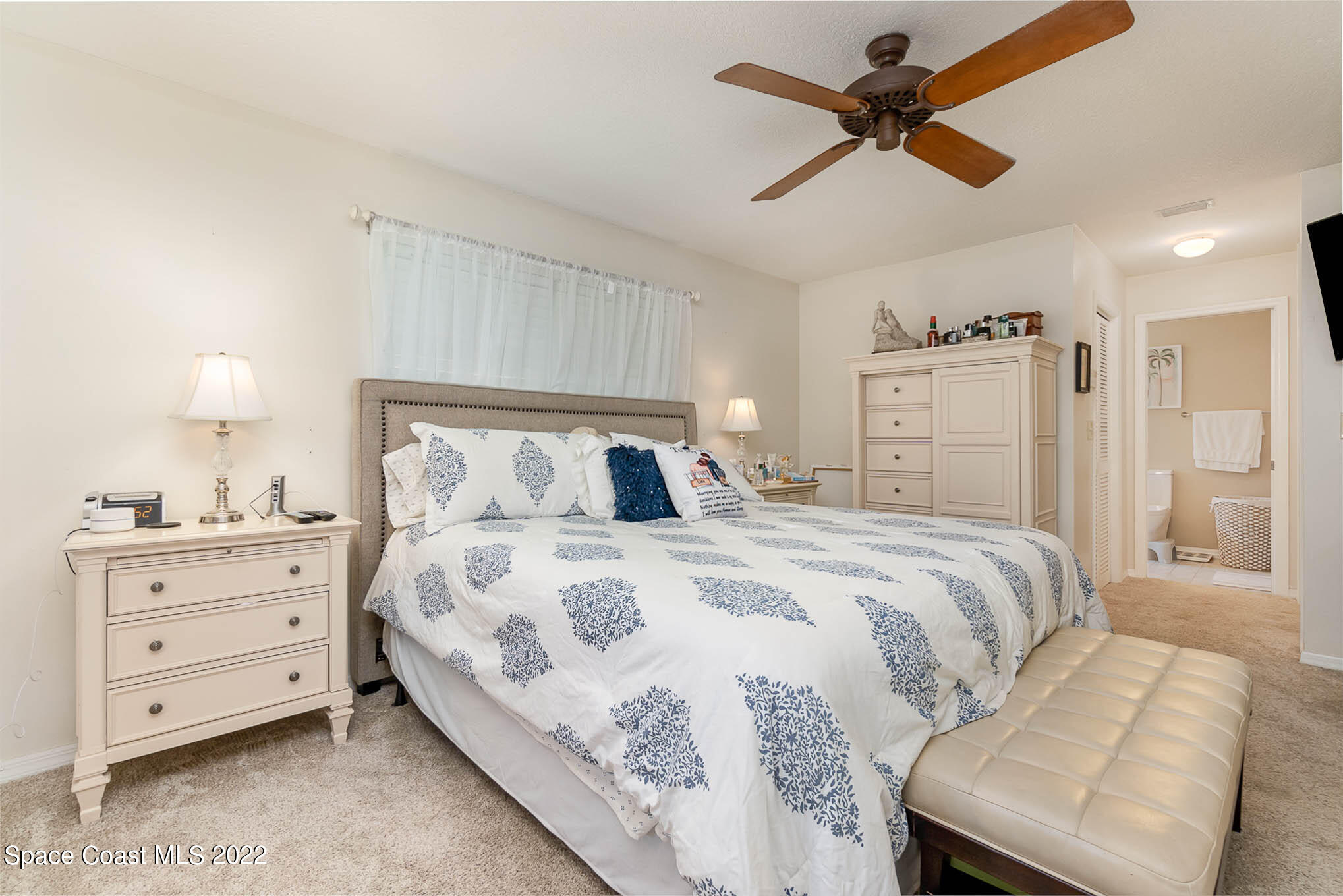 1496 Meadowbrook Road Northeast Palm Bay, FL 32905 - Photo 14 of 25 a bedroom with a bed and a ceiling fan