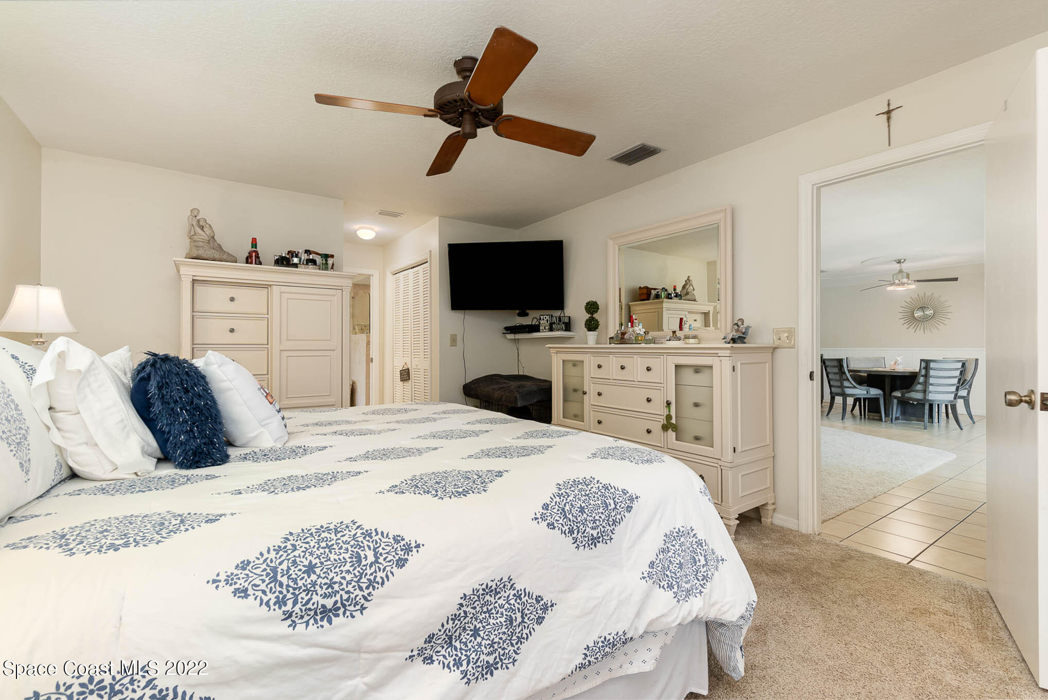 1496 Meadowbrook Road Northeast Palm Bay, FL 32905 - Photo 15 of 25 a bedroom with a bed and a flat screen tv