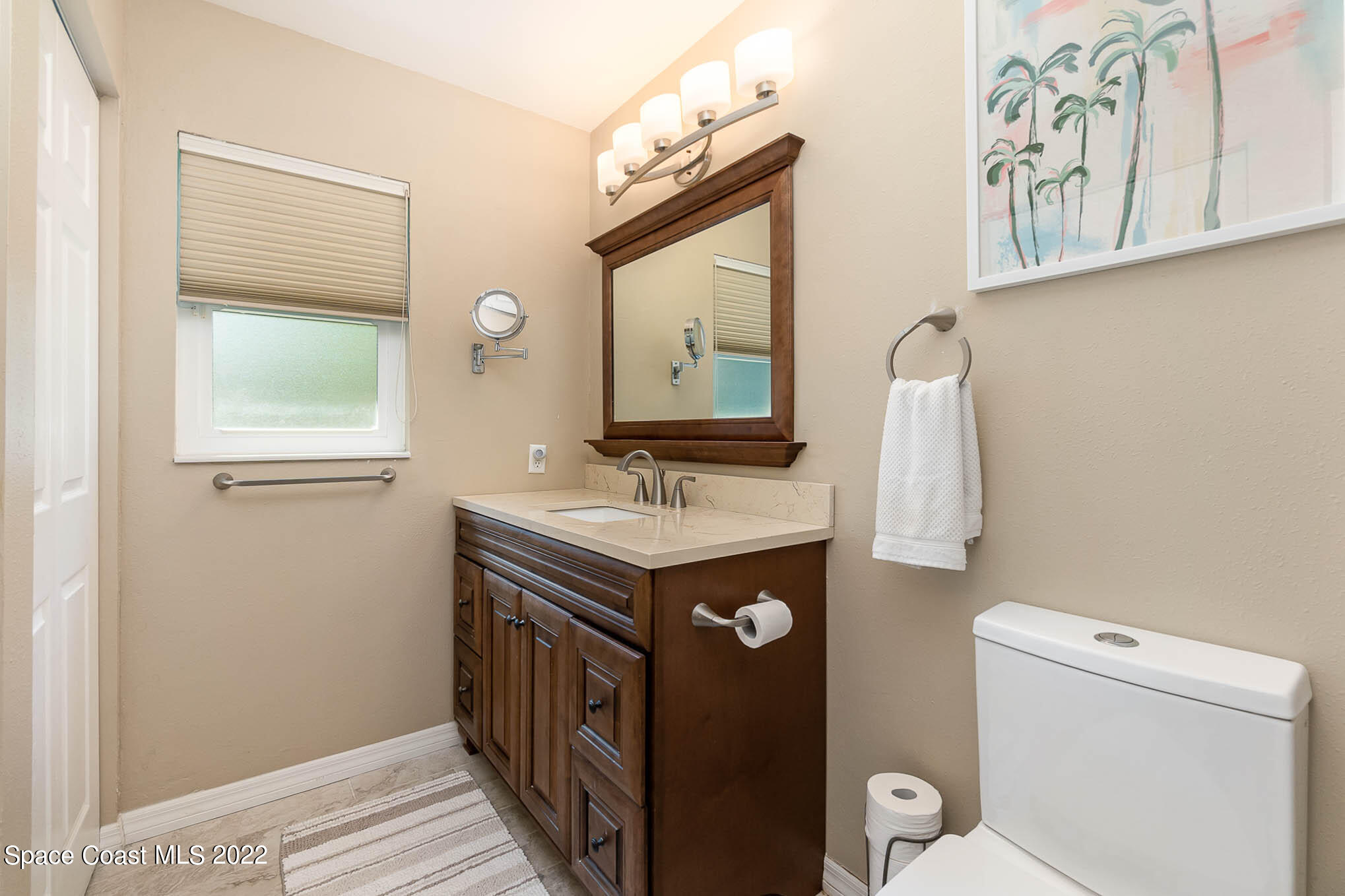1496 Meadowbrook Road Northeast Palm Bay, FL 32905 - Photo 16 of 25 a view of bathroom with a sink and a toilet